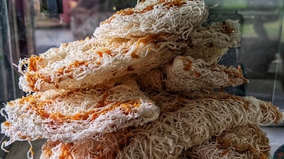 One of the traditional dishes is aasmi, a deep-fried sweet snack made with rice flour and coconut milk, which is rarely served in contemporary restaurants.