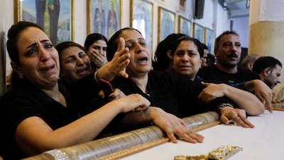 Grieving family members at a joint funeral service. Reuters