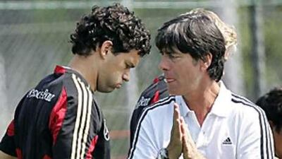 Joachim Low, right, has called for a meeting with his captain Michael Ballack, left, after comments the player made about his national coach.