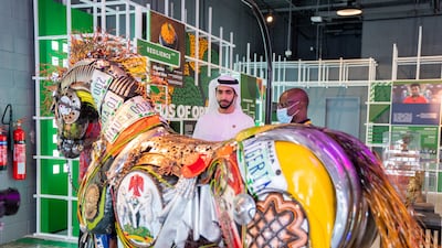 Sheikh Shakhbout views a horse-shaped artwork at one of the African pavilions.