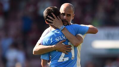 Manchester City manager Pep Guardiola embraces midfielder David Silva, who played his 400th game for Manchester City against Bournemouth. AFP
