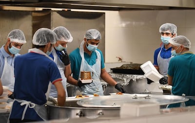 Volunteers in Dubai prepare iftar meals for blue-collar workers during Ramadan, on April 28, 2020. AFP