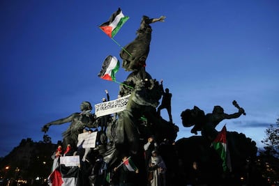Protesters with a banner that reads 'Support to Palestinian and Israeli innocents' hold a rally in central Paris demanding an immediate ceasefire in Gaza. AFP