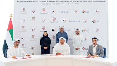Dr Sultan Al Jaber, Minister of Industry and Advanced Technology (back centre) and Sarah Al Amiri, Minister of State for Public Education and Advanced Technology (back left) attend the signing of the agreement. Photo: MoIAT
