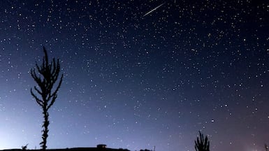 A Geminid meteor shower streaks across the night sky over Skopska Crna Gora mountain, in North Macedonia. EPA