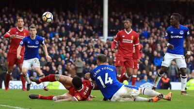 Cenk Tosun, centre, had a late chance to win the game for Everton and end the club's eight-year wait for a win in the Merseyside derby but his effort went wide. Peter Byrne / PA