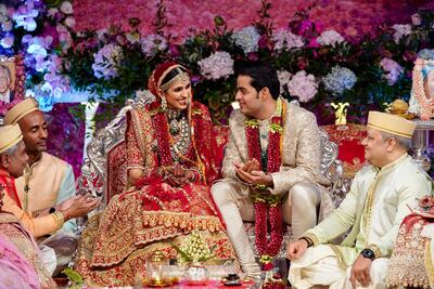 Akash Ambani and his wife Shloka Mehta smile as they perform a ritual at their wedding ceremony in Mumbai, India. Reliance Industries Limited Photo via AP