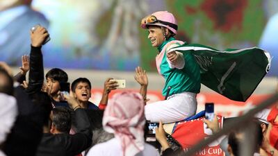 Jockey Mike Smith celebrates atop Arrogate following the main event of the Dubai World Cup at Meydan Racecourse in Dubai. Pawan Singh / The National