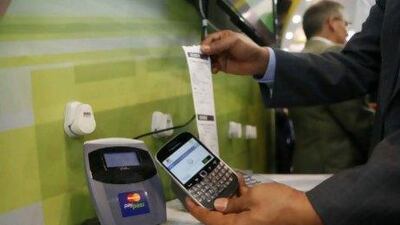 An Etisalat employee demonstrates the new payment system. Antonie Robertson / The National