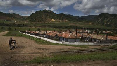 A North Korean man pushes his bicycle in to a village in North Korea’s North Hamgyong province.