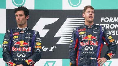 Red Bull Racing’s Mark Webber, left, did not look best impressed after teammate Sebastian Vettel ignored team orders to win in Malaysia. Diego Azubal / EPA