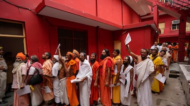 Hindu holy men stand in a queue in Jammu, India, to register for the annual pilgrimage to the Amarnath cave shrine. AP