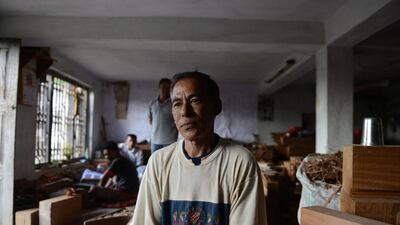 Nepalese woodcarver Hari Bahadur Shilpakar sits in his workshop in Bhaktapur on the outskirts of Kathmandu. Prakash Mathema / AFP