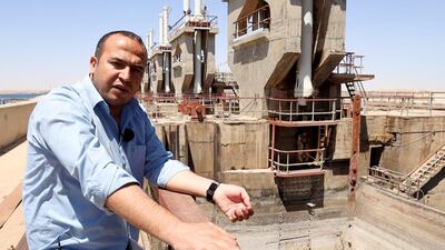 Welat Derwish, the regional director of water administration on in the Syrian democratic forces, stands on Tapqa dam where his office located and he shows us the water level low 5 meters. Photo by Daham Alasaad