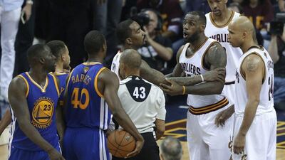 Cleveland Cavaliers forward LeBron James (23) is held back as he argues with Golden State Warriors forward Draymond Green (23) during the second half of Game 4 of basketball's NBA Finals in Cleveland, Friday, June 10, 2016. Golden State won 108-97. (AP Photo/Tony Dejak)