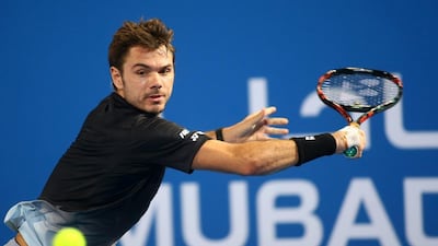 Stan Wawrinka returns the ball to Milos Raonic. Marwan Naamani / AFP