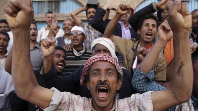 Protesters shout slogans against the Houthi movement in the southwestern Yemen city of Taiz. (Mohamed al-Sayaghi / Reuters)