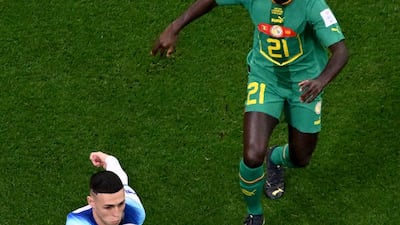 England's Phil Foden breaks with Senegal's Youssouf Sabaly in pursuit. AFP