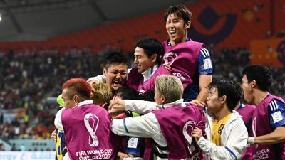 Japan's Ritsu Doan celebrates scoring their first goal with teammates. Reuters