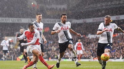 epa05196139 Arsenal's Alexis Sanchez (L) scores against Tottenham during an English Premier League soccer match at White Heart Lane in London, Britain, 05 March 2016. EPA/ANDY RAIN EDITORIAL USE ONLY. No use with unauthorized audio, video, data, fixture lists, club/league logos or 'live' services. Online in-match use limited to 75 images, no video emulation. No use in betting, games or single club/league/player publications.