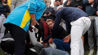 Brooks Koepka of the US offers a golf glove to an unidentified injured woman after his ball hit her on the 6th hole. AP Photo