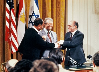 Egyptian president Anwar Al Sadat, Israeli premier Menachem Begin and US president Jimmy Carter shake hands in 1978, a year before the peace treaty was signed. AFP