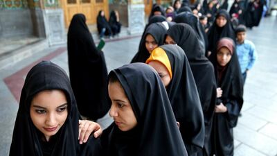 Iranian women stand in line at a polling station during the parliamentary and Experts Assembly elections in Qom, south of Tehran, Iran. Ebrahim Noroozi / AP Photo