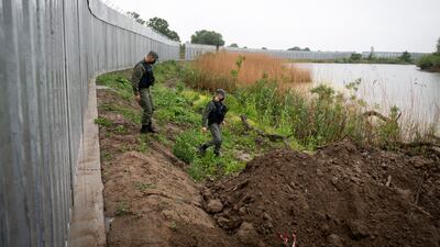 Greek border police patrol alongside a steel wall at the border with Turkey. AP