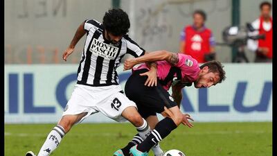 Turn for the better: Siena's Luis Novo Neto, left, slips past Juventus' Claudio Marchisio during their Serie A match. Alessandro Bianchi / Reuters