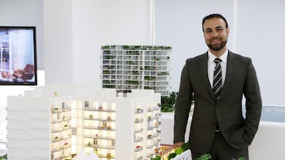 Azizi Developments’ chief executive Farhad Azizi shows some of the company's scaled projects. Pawan Singh / The National