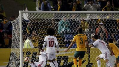 Australia's Jason Davidson, No 3, scores his side's second goal in their Asian Cup semi-final victory over UAE on Tuesday. Edgar Su / Reuters