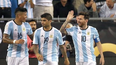 Lionel Messi, right, of Argentina celebrates his goal with Marcos Rojo, left, and Ever Banega in the second half during the 2016 Copa America Centenario quarterfinal match against Venezuela at Gillette Stadium on June 18, 2016 in Foxboro, Massachusetts. Jim Rogash/Getty Images/AFP