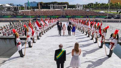 Jair Bolsonaro, his wife Michelle Bolsonaro, Brazil's new Vice-President Hamilton Mourao and his wife Paula Mourao are welcomed by outgoing president Michel Temer and his wife Marcela Temer. AFP