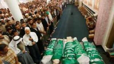 Palestinians pray beside the bodies of Hamas gunmen during their funeral on Wednesday.