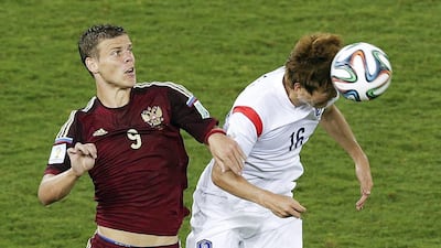 Russia's Alexander Kokorin, left, vies in the air for the ball with South Korea's Ki Sung-yueng, right, during their match on Tuesday at the 2014 World Cup in Cuiaba, Brazil. Thanassis Stavrakis / AP