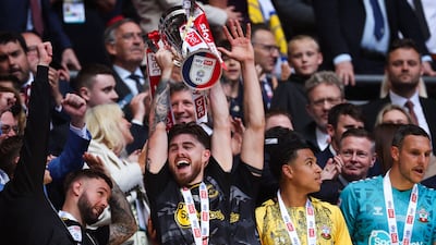 Southampton's Irish defender Ryan Manning lifts the Championship play-off trophy. AFP