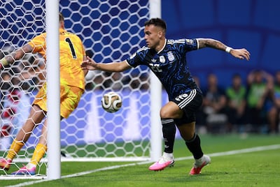 Lautaro Martinez wheels away in celebration after heading in Argentina's winner against England. AFP