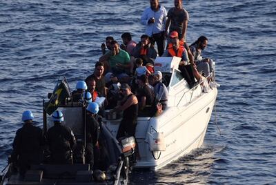A UN boat approaches a boat overcrowded with migrants in the Mediterranean Sea off the coast of Lebanon. AP