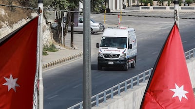 An ambulance drives along an empty road during a Covid-19 lockdown in Jordan's capital Amman on October 9, 2020. AFP
