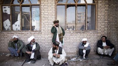Afghan residents queue to receive their voter cards for the upcoming presidential election at a voter registration centre in the northwestern city of Herat. Behrouz Mehri / AFP