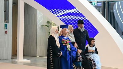 Family and friends take photos with the graduates at the Mohamed bin Zayed University of Artificial Intelligence commencement of class 2023 ceremony.