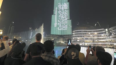 The Burj Khalifa lights up with Saudi Arabia's flag. The UAE and the kingdom are the two biggest insurance markets in the GCC. Satish Kumar for The National