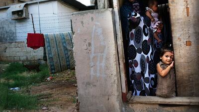 A Syrian refugee family from the Deir el Zour, Syria pauses in their doorway in a neighborhood with a high concentration of Syrian refugees in Beirut, Lebanon. Spencer Platt / Getty Images