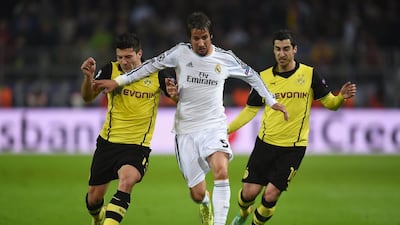 Fabio Coentrao of Real Madrid is challenged by Milos Jojic, left, and Henrikh Mkhitaryan of Borussia Dortmund during Tuesday night’s Champions League quarter-final match. Lars Baron / Bongarts / Getty Images / April 8, 2014
