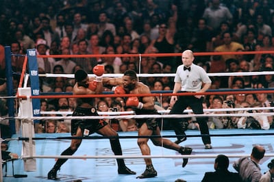 Mike Tyson (right) fights heavyweight champion Trevor Berbick to become the youngest heavyweight world champion in history in Las Vegas on November 22, 1986. AFP