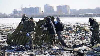 Russian Police and Emergency Ministry employees investigate the wreckage of the crashed plane at the Rostov-on-Don airport. Investigators were to spend the day combing the scene for clues of what caused the crash. AP Photo
