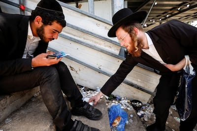An ultra-Orthodox Jewish man prepares to light candles at the site where dozens were crushed to death in a stampede during the Lag BaOmer festival. Reuters