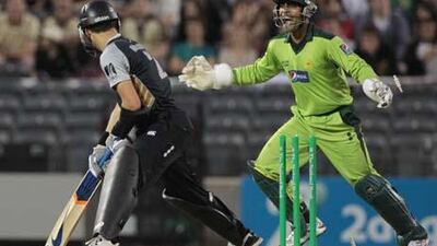 Pakistan wicketkeeper Umar Akmal celebrates after New Zealand batsman Peter McGlashan is bowled out for 7 runs.