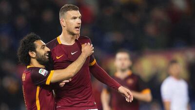 AS Roma's Edin Dzeko, right, celebrates with teammate Mohamed Salah on Sunday during their Serie A win over Palermo. Claudio Peri / EPA / February 21, 2016