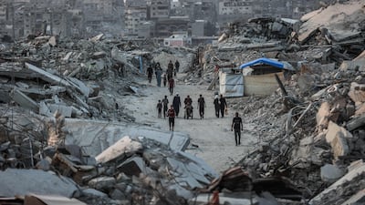 Palestinians walk amid the rubble of destroyed buildings in Jabalia, in the northern Gaza Strip. AFP